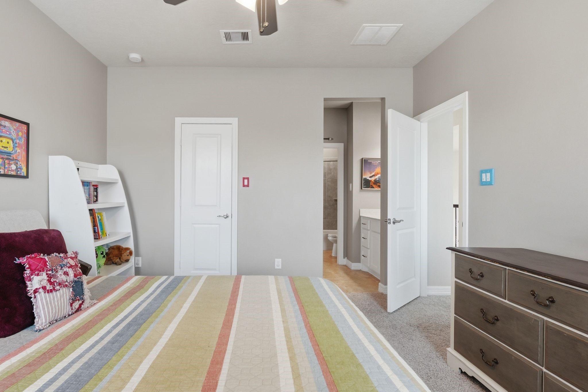 27705 South Slate Hills Lane Spring, TX 77386 - Photo 24 of 45 Spaciously laid out secondary upstairs bedroom featuring a, walk-in closet with built-in shelving. This room is connected to the third upstairs bedroom by a Hollywood Bathroom with seperate vanity spaces in each bedroom with a door that separates it from the shower/toilet area.
