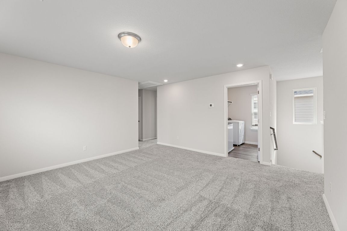 354 Lost Mine Peak Lane Dripping Springs, TX 78620 - Photo 11 of 26 Game room looking back at the staircase and the utility room.