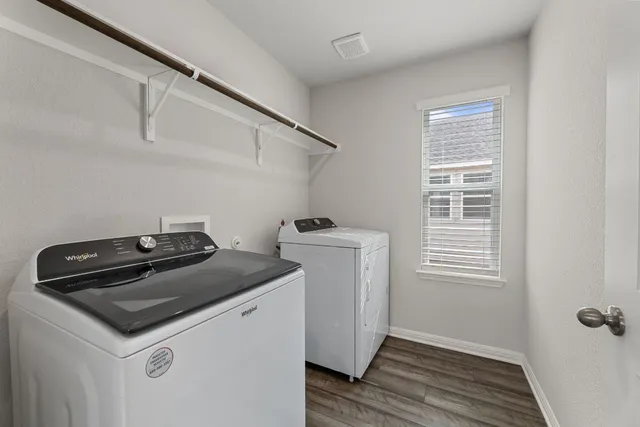 a utility room with closet dryer and washer