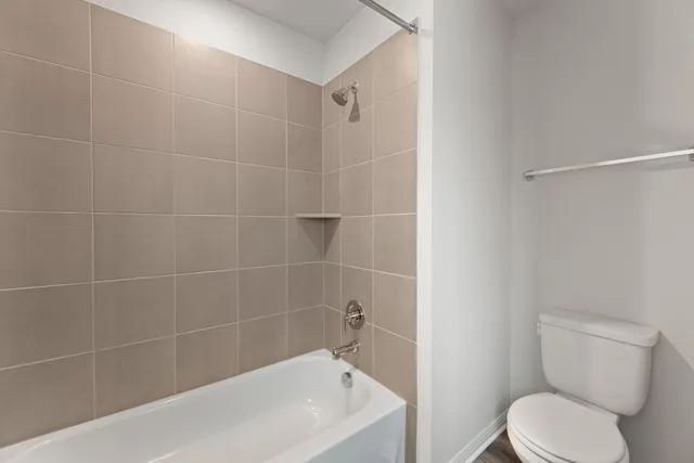 a white bath tub sitting next to a white toilet