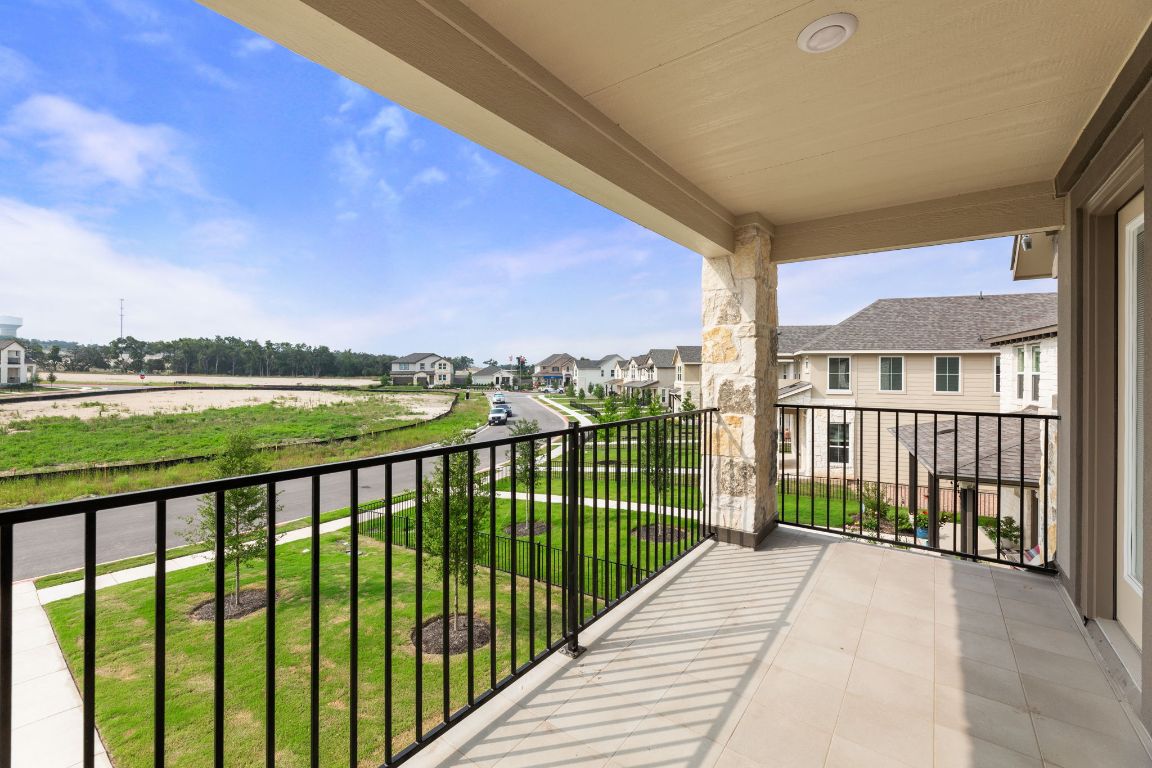 354 Lost Mine Peak Lane Dripping Springs, TX 78620 - Photo 24 of 26 Balcony off the main bedroom overlooks the peaceful green space.
