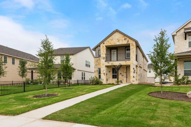 a front view of house with yard and green space