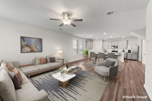 a living room with furniture and wooden floor