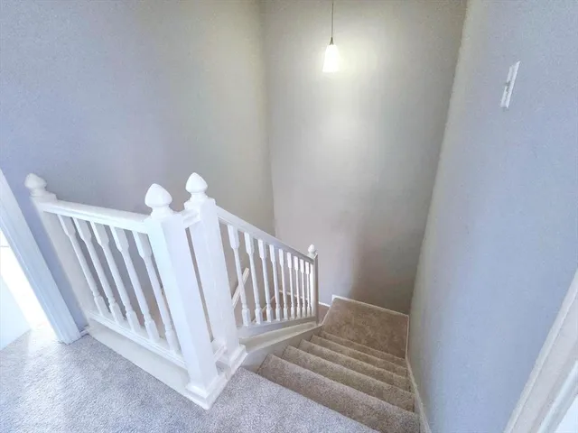 a view of a bedroom with wooden floor
