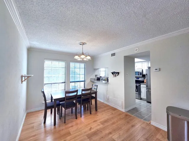 a view of a a dining room with furniture window and wooden floor