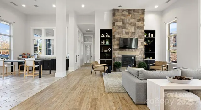 a living room with fireplace furniture and a wooden floor
