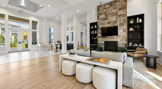 a living room with furniture a flat screen tv and a fireplace