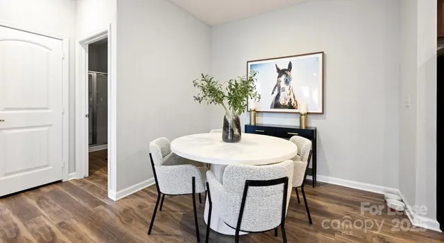 a dining room with furniture and wooden floor