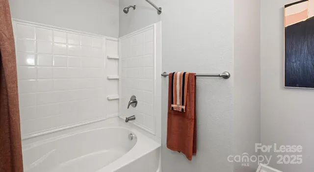a bathroom with a bathtub and shower