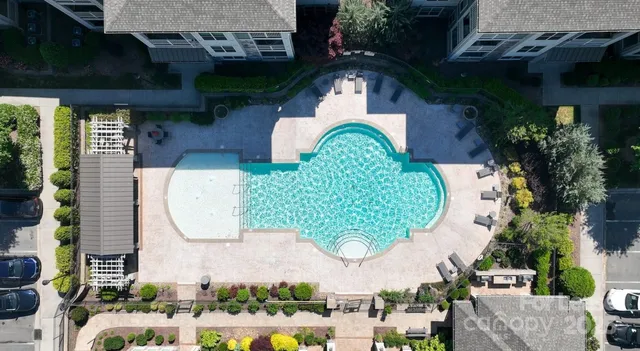 an aerial view of a house with a swimming pool and outdoor seating