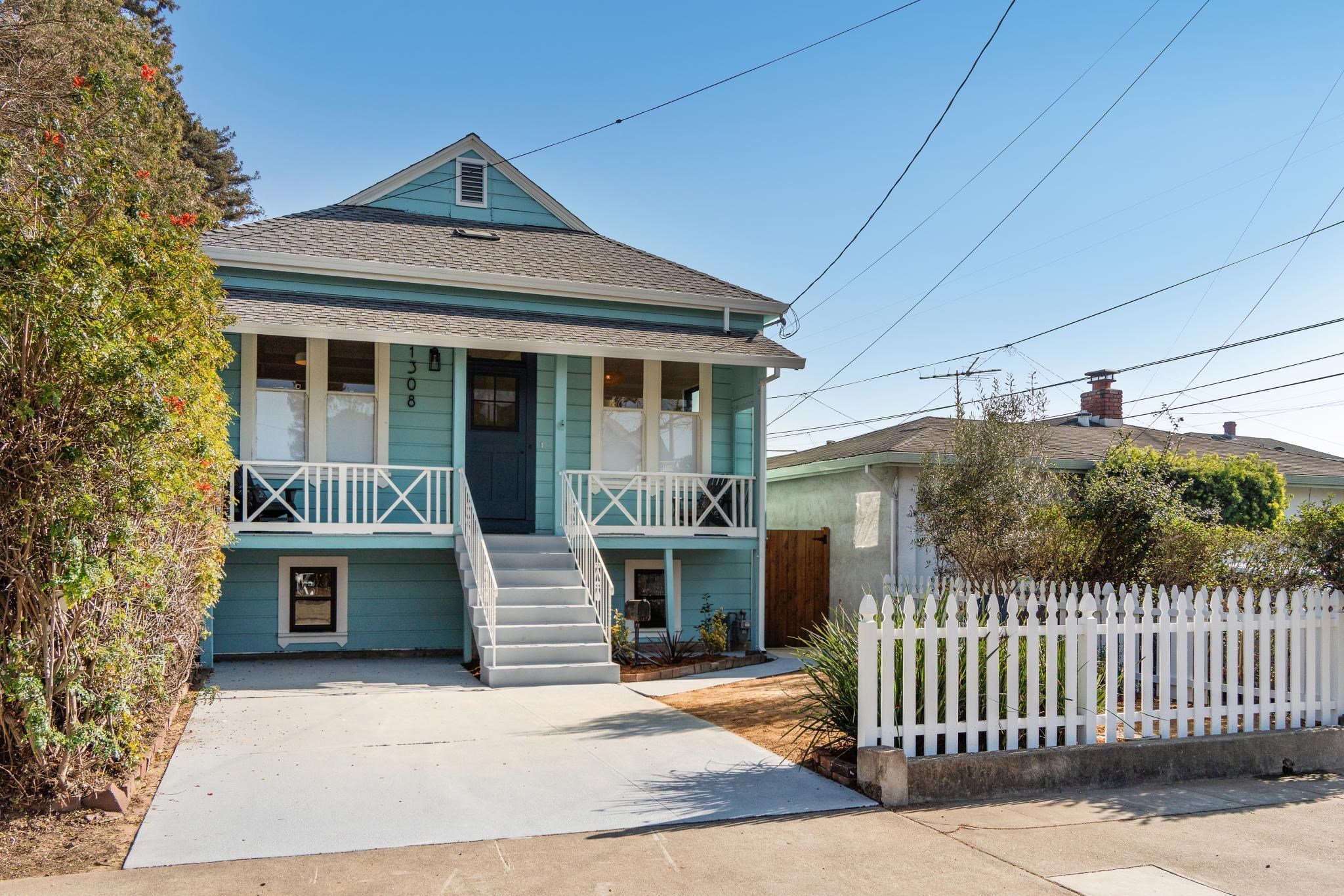 View of front of property featuring a porch and a shingled roof