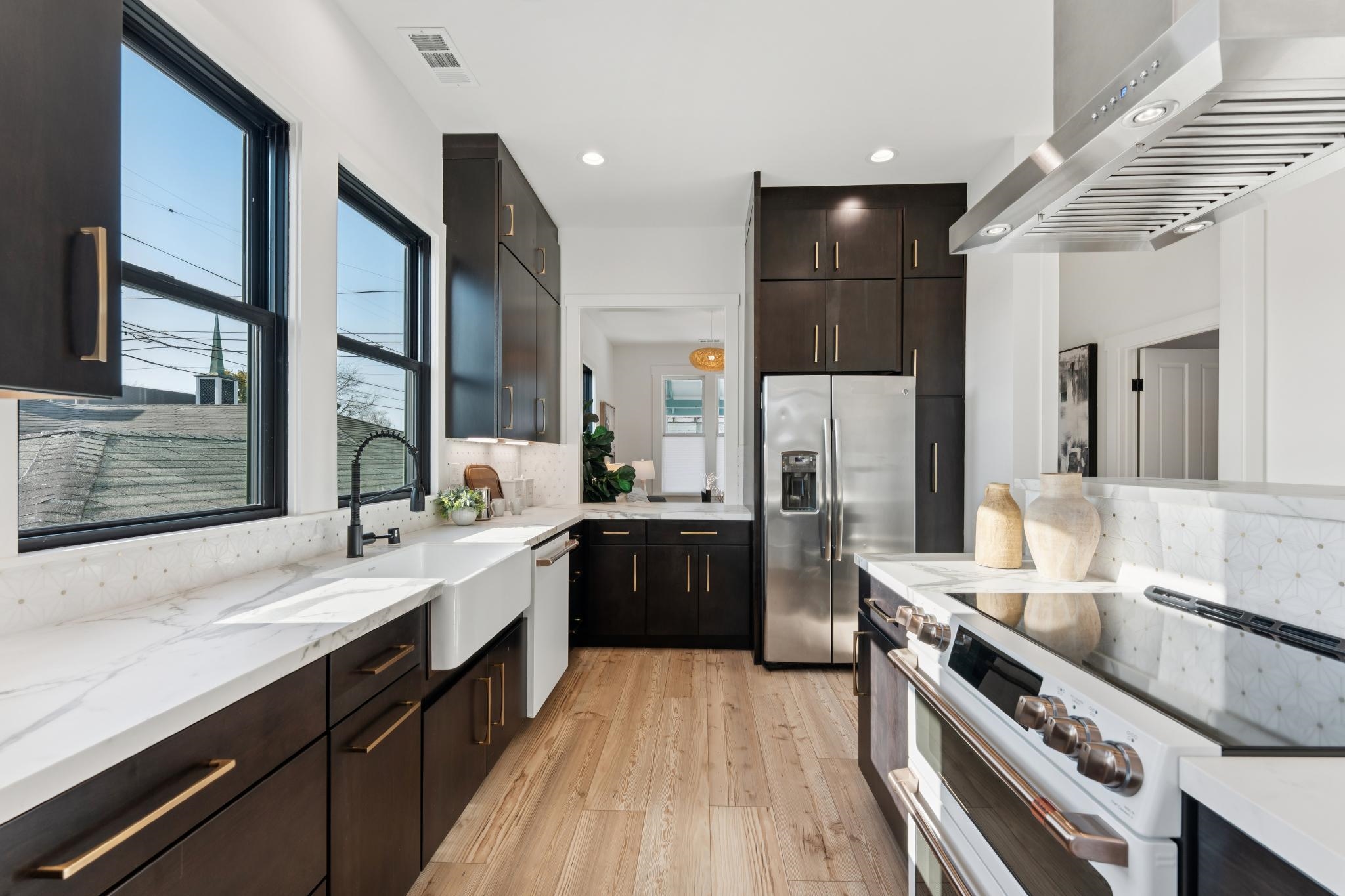 1308 Court Street Alameda, CA 94501 - Photo 30 of 60 Kitchen featuring white appliances, light stone counters, light wood finished floors, recessed lighting, and dark wood finish cabinets