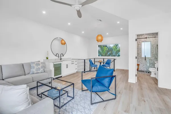 a view of house with swimming pool and furniture