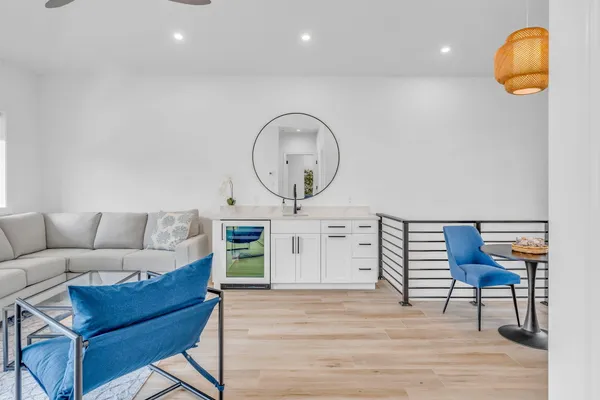 a view of a chair and tables in the back yard of the house