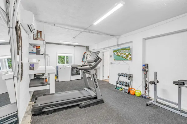 an aerial view of a house with a garden and lake view