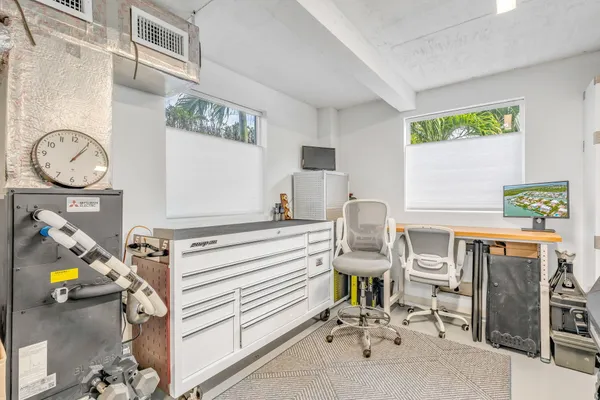 an aerial view of ocean and residential houses with outdoor space