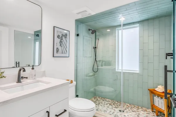 a view of a city with lots of residential buildings ocean and mountain view in back