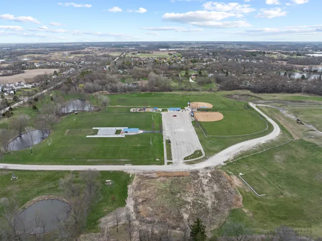 an aerial view of a golf course with parking space