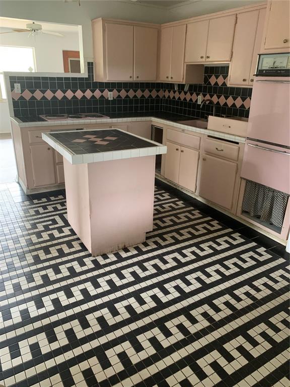 1063 40th Street Sarasota, FL 34234 - Photo 7 of 13 a kitchen with a stove a sink and cabinets