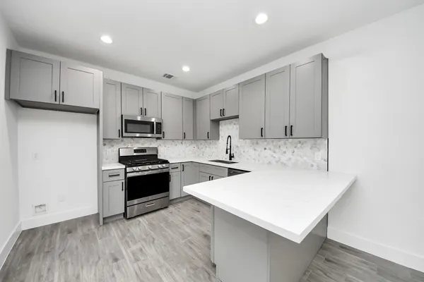 a kitchen with wooden cabinets and white appliances