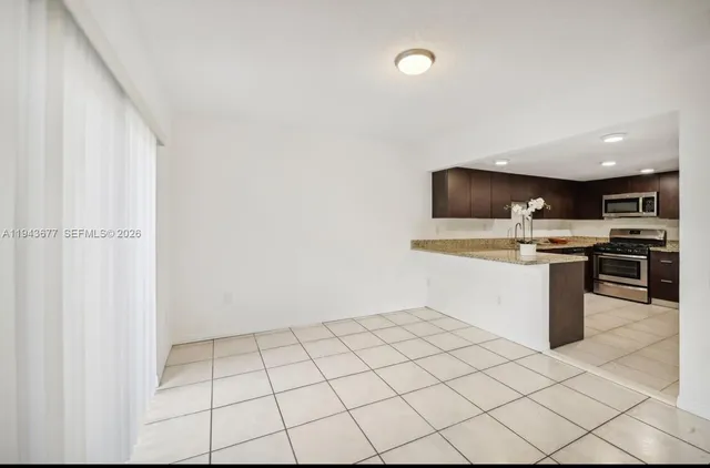 a kitchen with a sink a stove top oven and cabinets