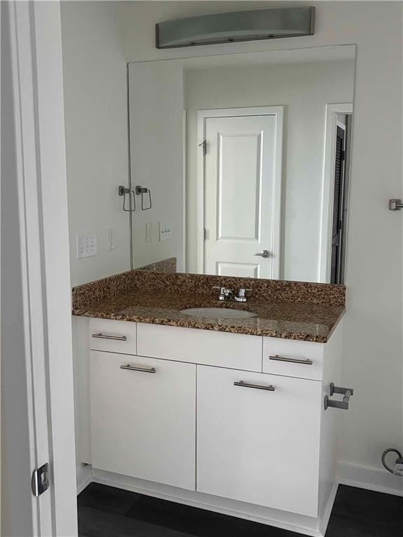 3324 Peachtree Road, Unit 2213 Atlanta, GA 30326 - Photo 10 of 28 a bathroom with a granite countertop sink and a mirror