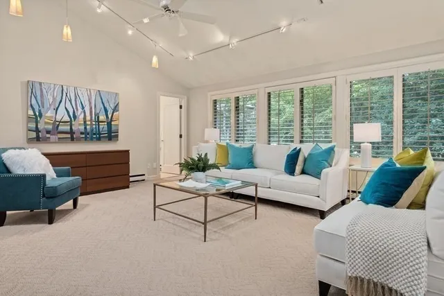 a bathroom with a granite countertop sink a toilet a mirror and bathtub