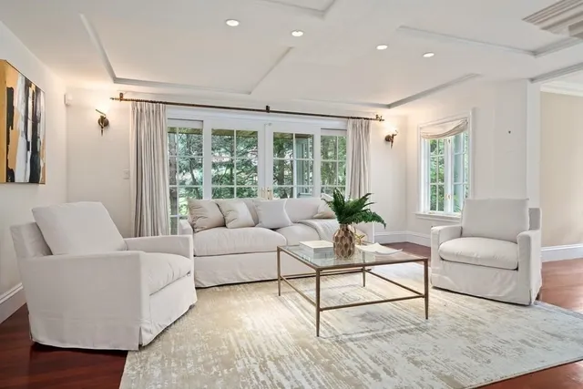 a spacious bedroom with a bed and wooden floor