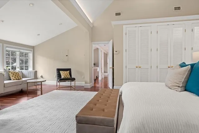 a living room with furniture and floor to ceiling windows