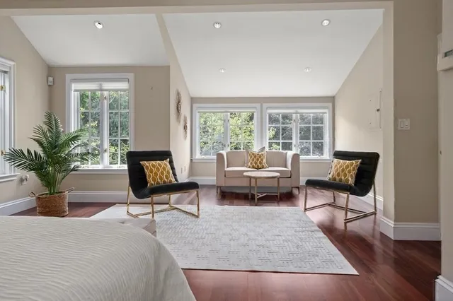 a bathroom with a tub sink and mirror