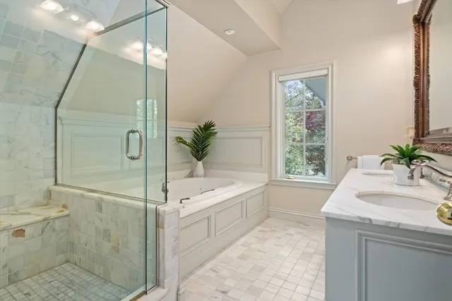 a spacious bathroom with a bathtub sink and mirror