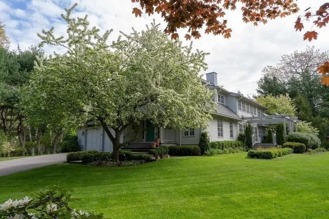 a front view of a house with a garden