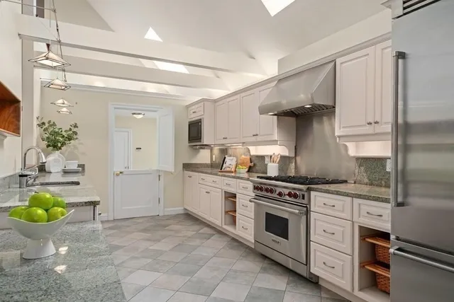 a large kitchen with stainless steel appliances lots of counter space sink and cabinets