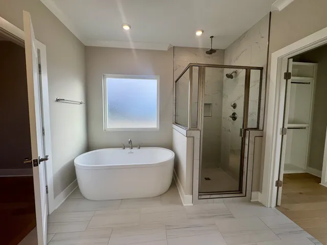 a spacious bathroom with a double vanity sink mirror and shower