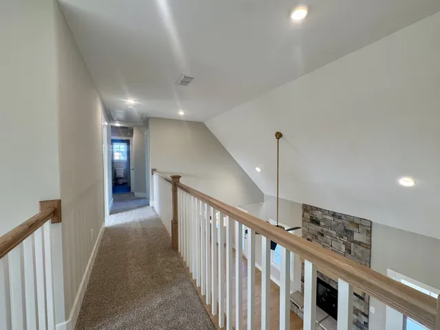 a view of a hallway with stairs