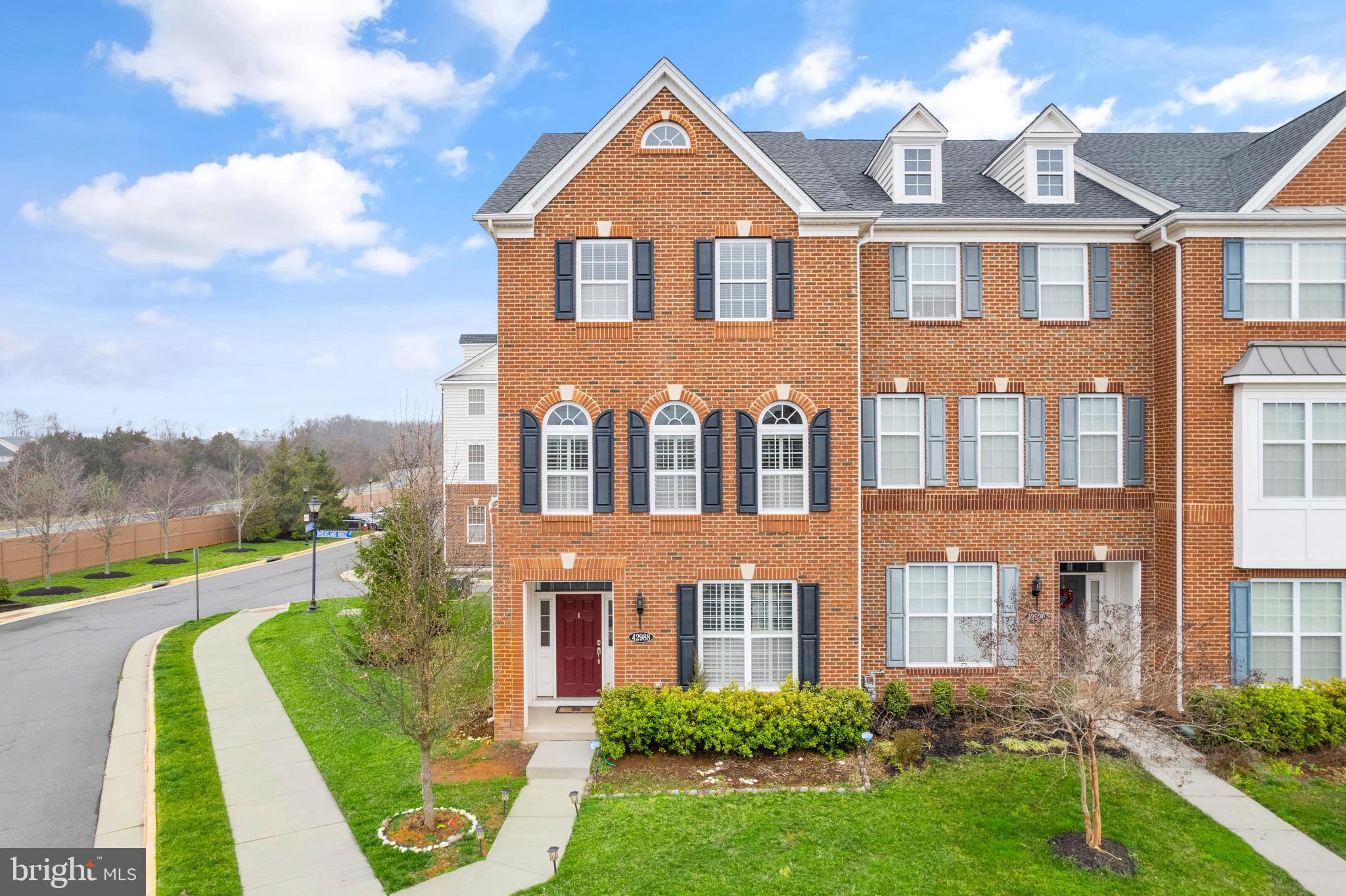 42988 Atoka Manor Terrace Ashburn, VA 20148 - Photo 1 of 47 a front view of a house with garden