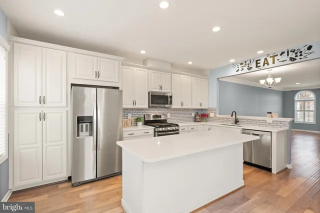 a kitchen with stainless steel appliances a refrigerator stove microwave and sink