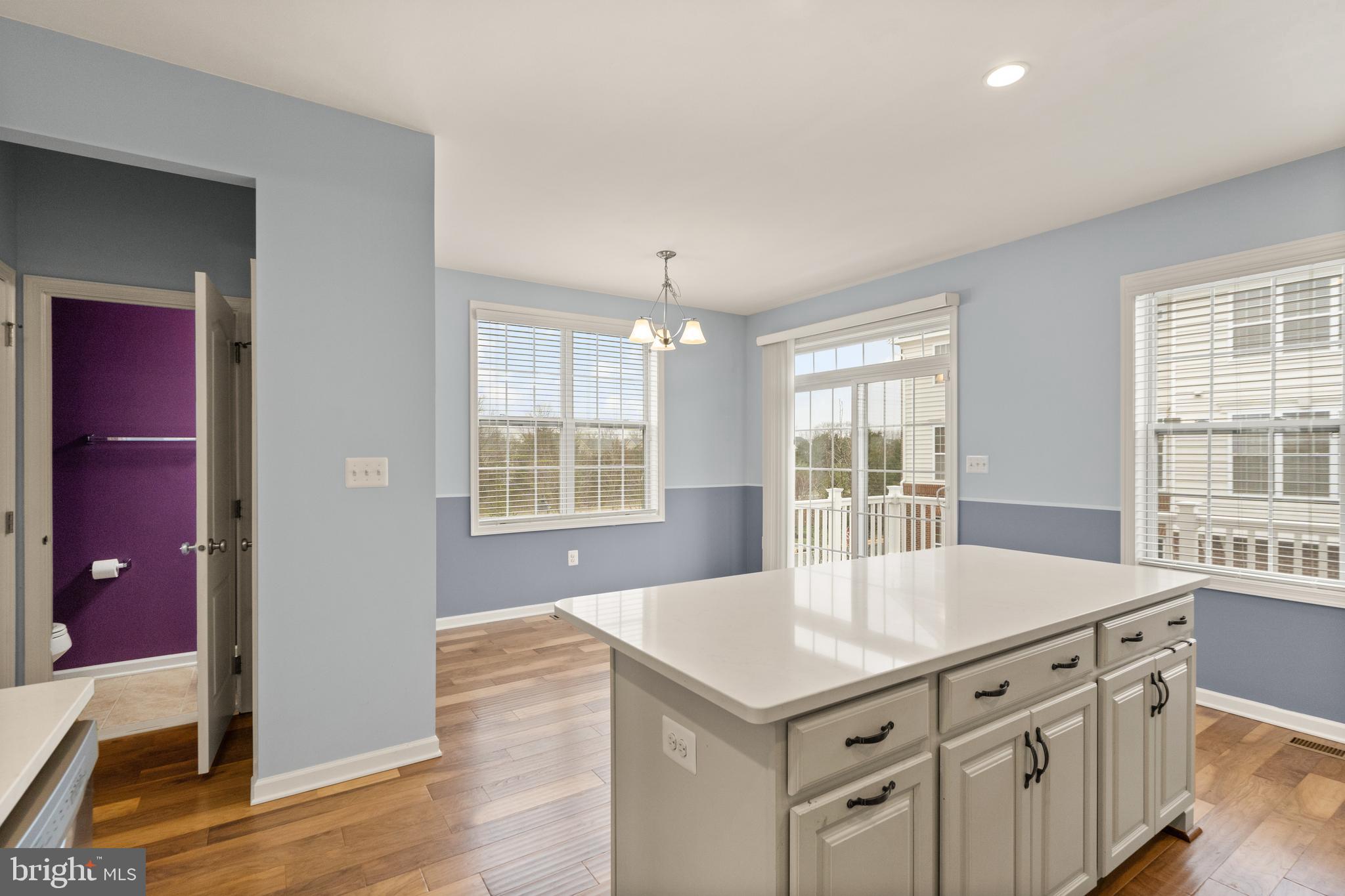 42988 Atoka Manor Terrace Ashburn, VA 20148 - Photo 17 of 47 a kitchen with stainless steel appliances a kitchen island hardwood floor and sink