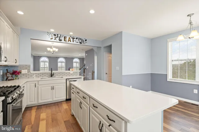 a large kitchen with a sink and cabinets