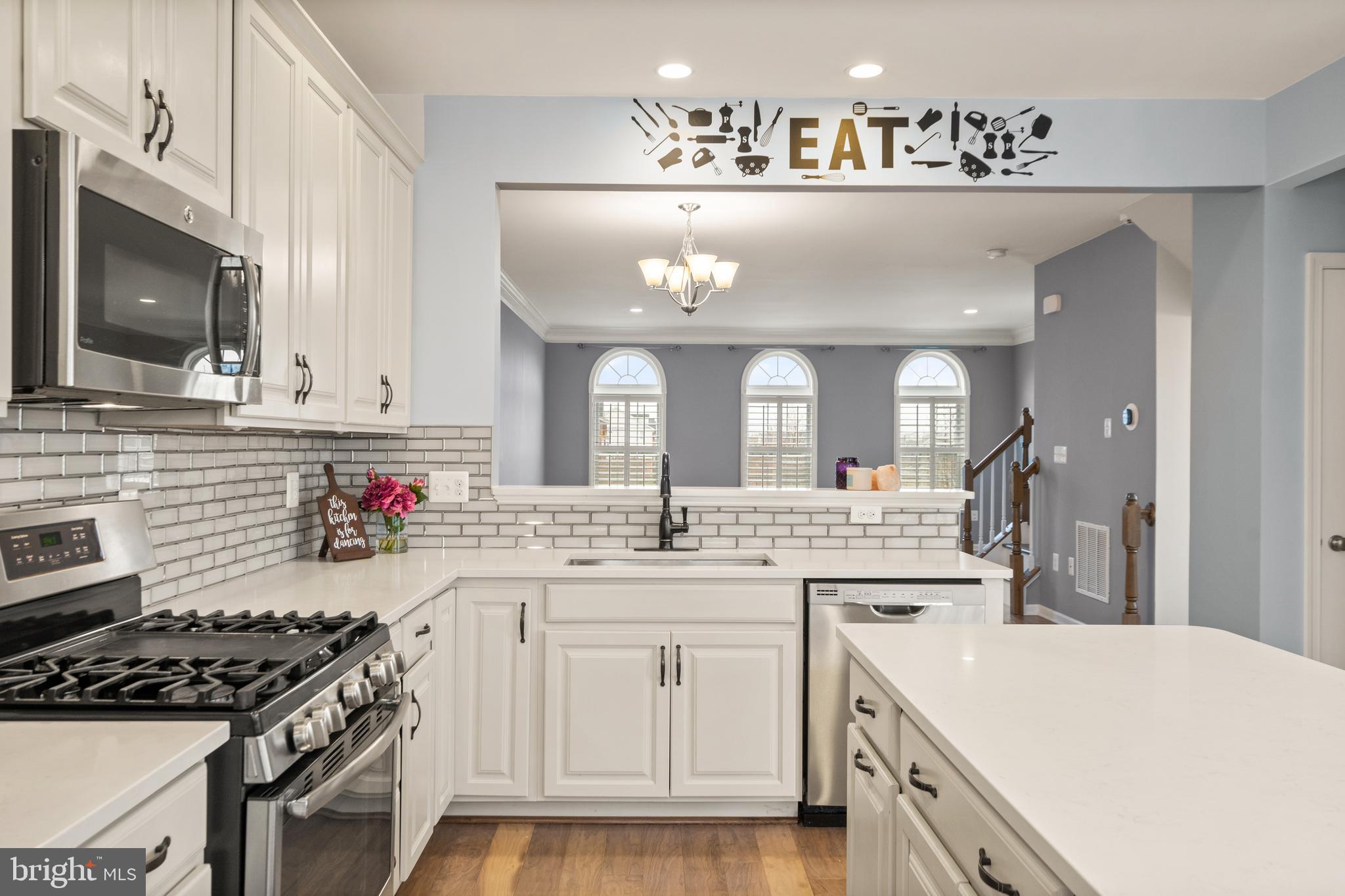 42988 Atoka Manor Terrace Ashburn, VA 20148 - Photo 19 of 47 a kitchen with a sink stove and cabinets