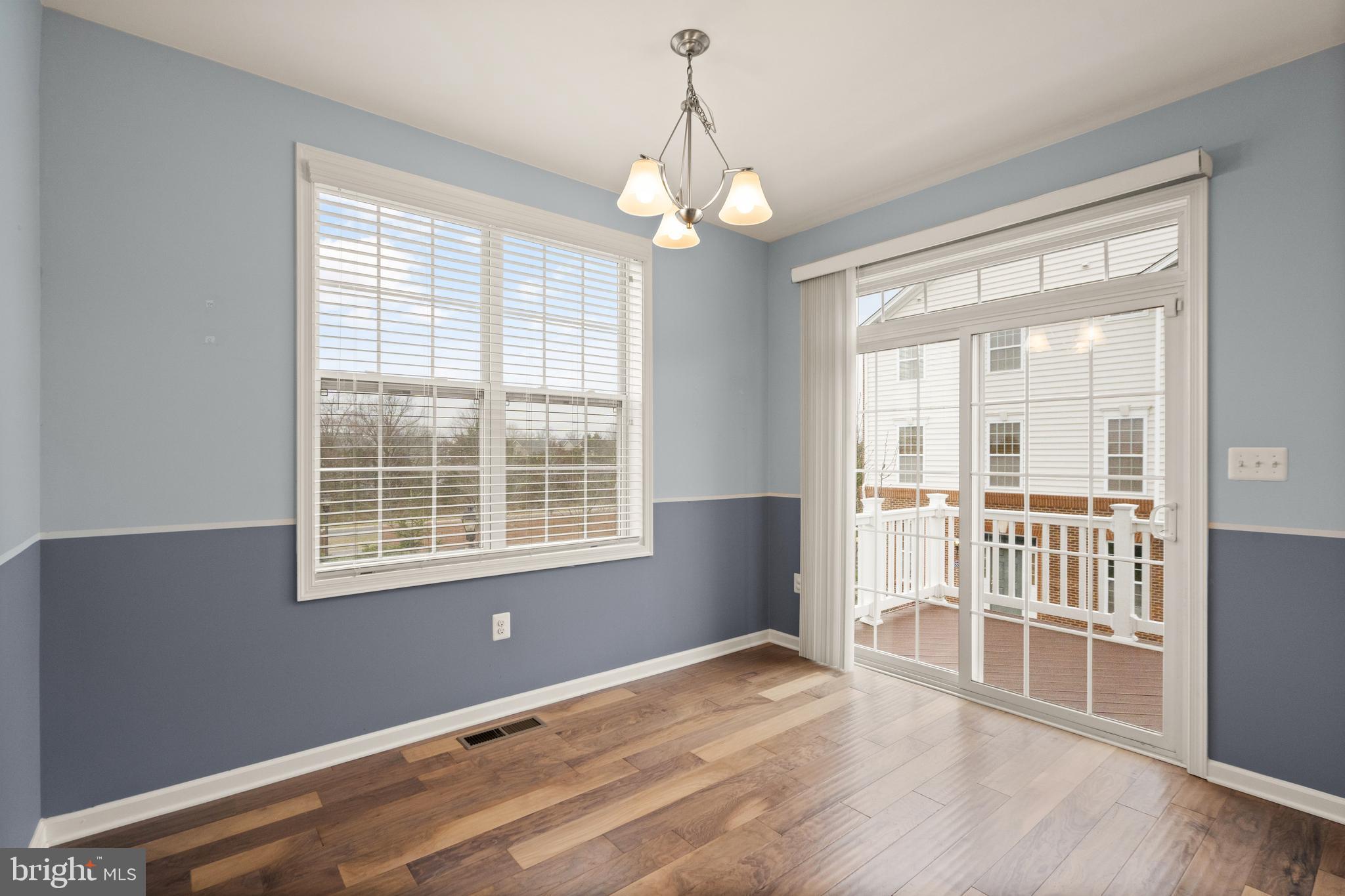 42988 Atoka Manor Terrace Ashburn, VA 20148 - Photo 20 of 47 a view of an empty room with wooden floor and a window