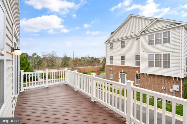 a view of a house with wooden deck