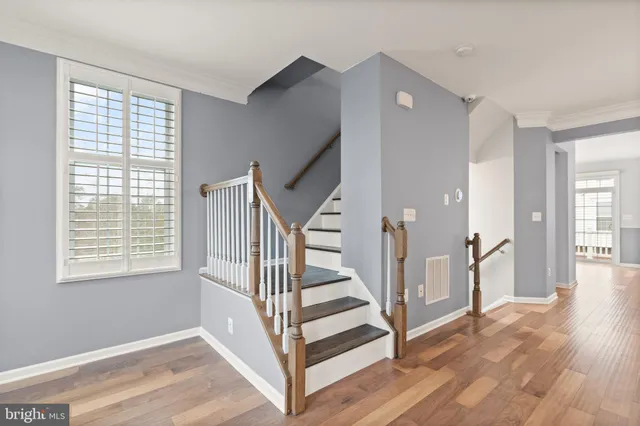 a view of entryway with wooden floor and stairs