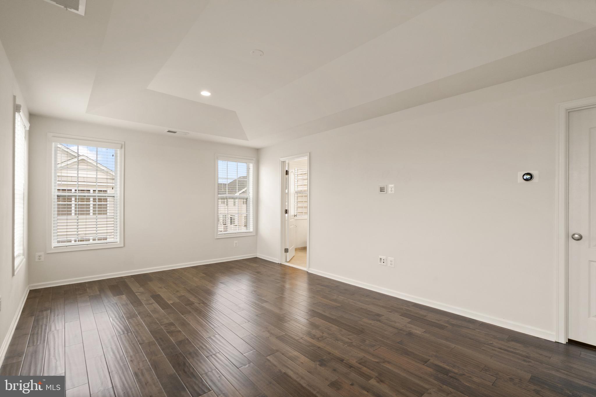 42988 Atoka Manor Terrace Ashburn, VA 20148 - Photo 30 of 47 a view of an empty room with wooden floor and a window