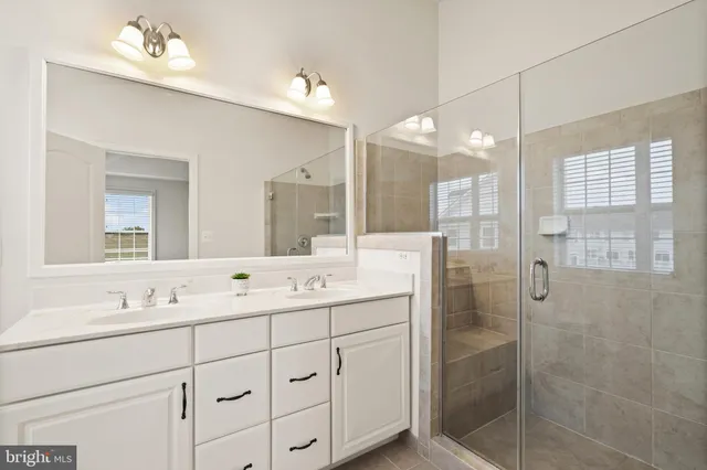 a bathroom with a double vanity sink mirror and double