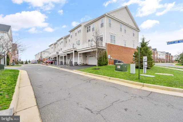 a view of a white house with a yard