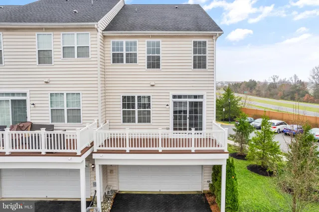 a view of a house with a deck and a yard