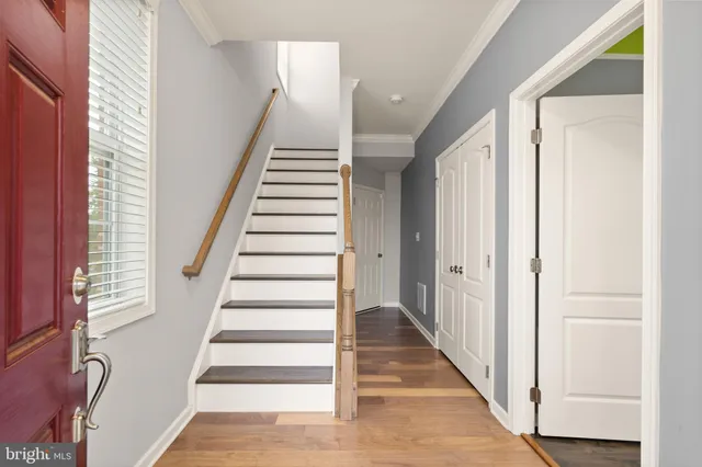 a view of a hallway with wooden floor and entryway