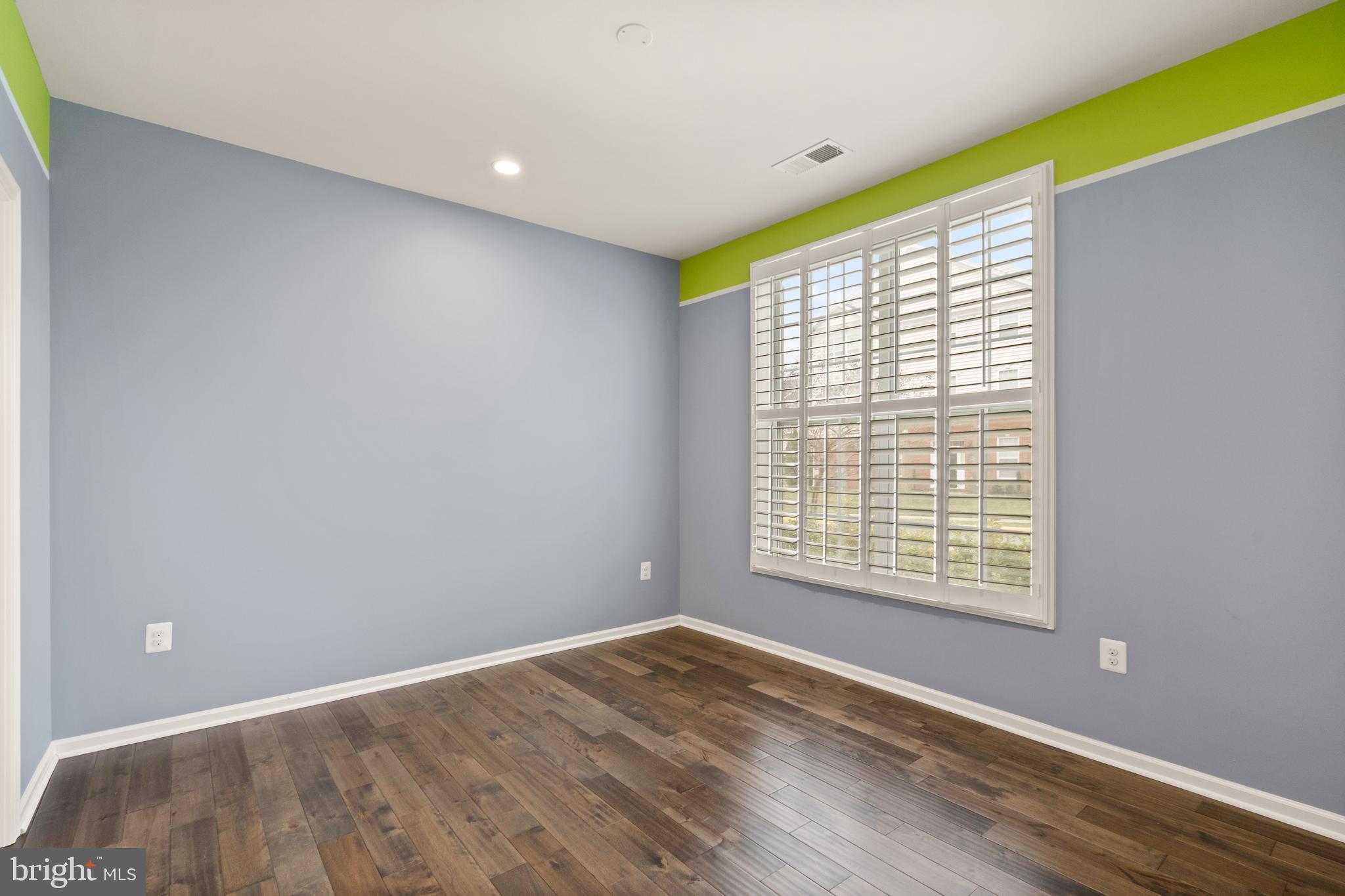 42988 Atoka Manor Terrace Ashburn, VA 20148 - Photo 9 of 47 a view of an empty room with wooden floor and a window