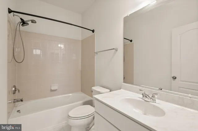 a bathroom with a sink toilet tub and shower